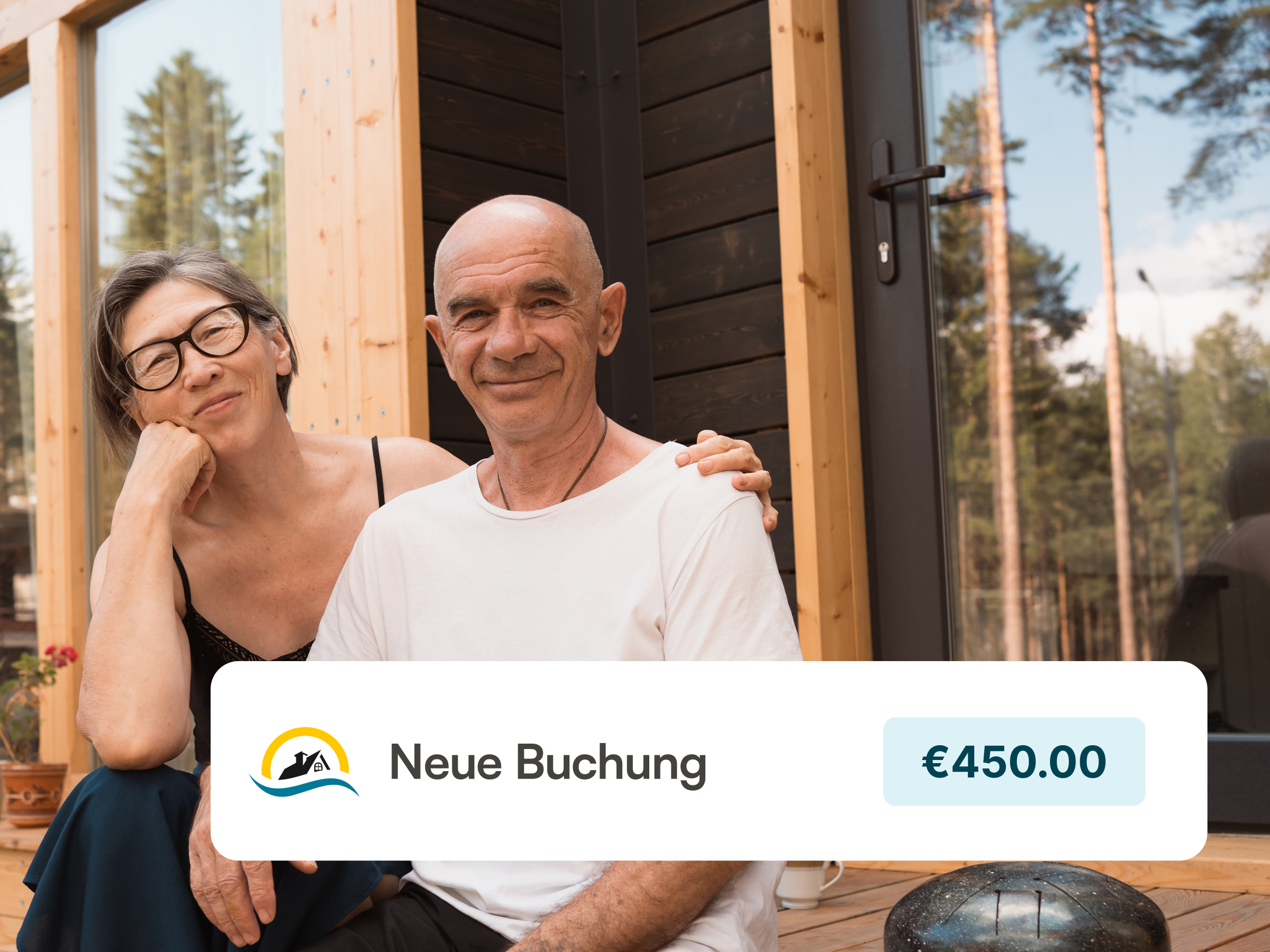 Two happy hosts in front of their vacation rental with a wooden porch