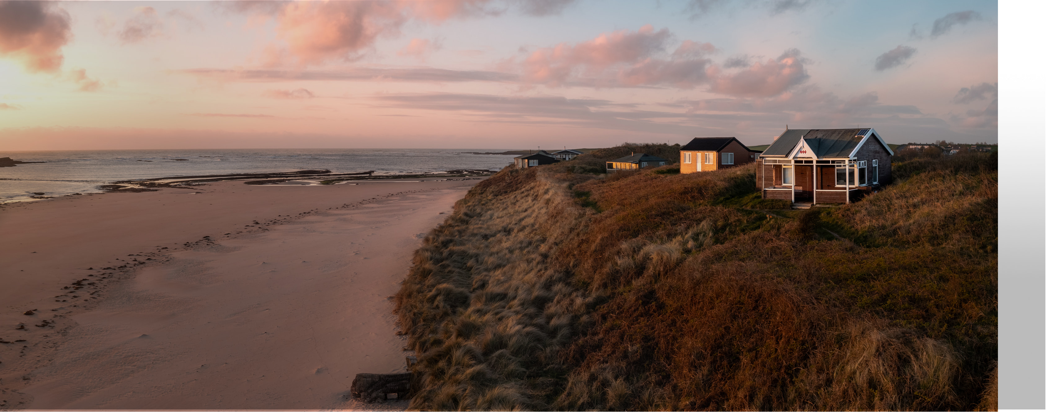 Cottages on the english coast overlooking the sunset and ocean