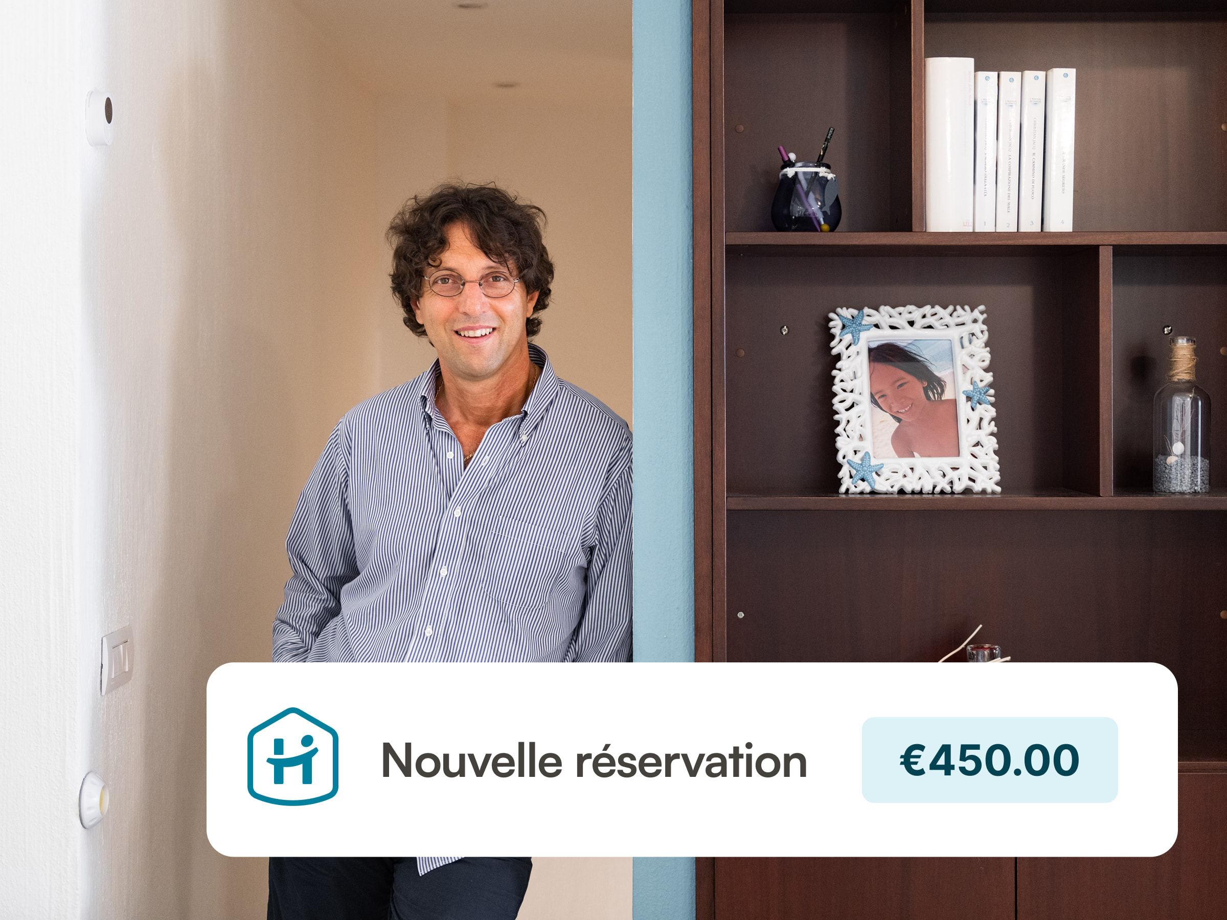 A host is standing in his vacation property leaning against a wall
