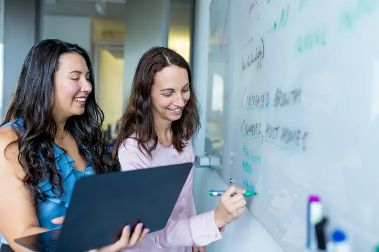 collegues writing on the whiteboard
