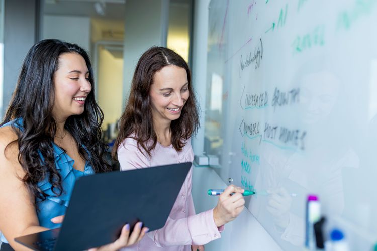 collegues writing on the whiteboard