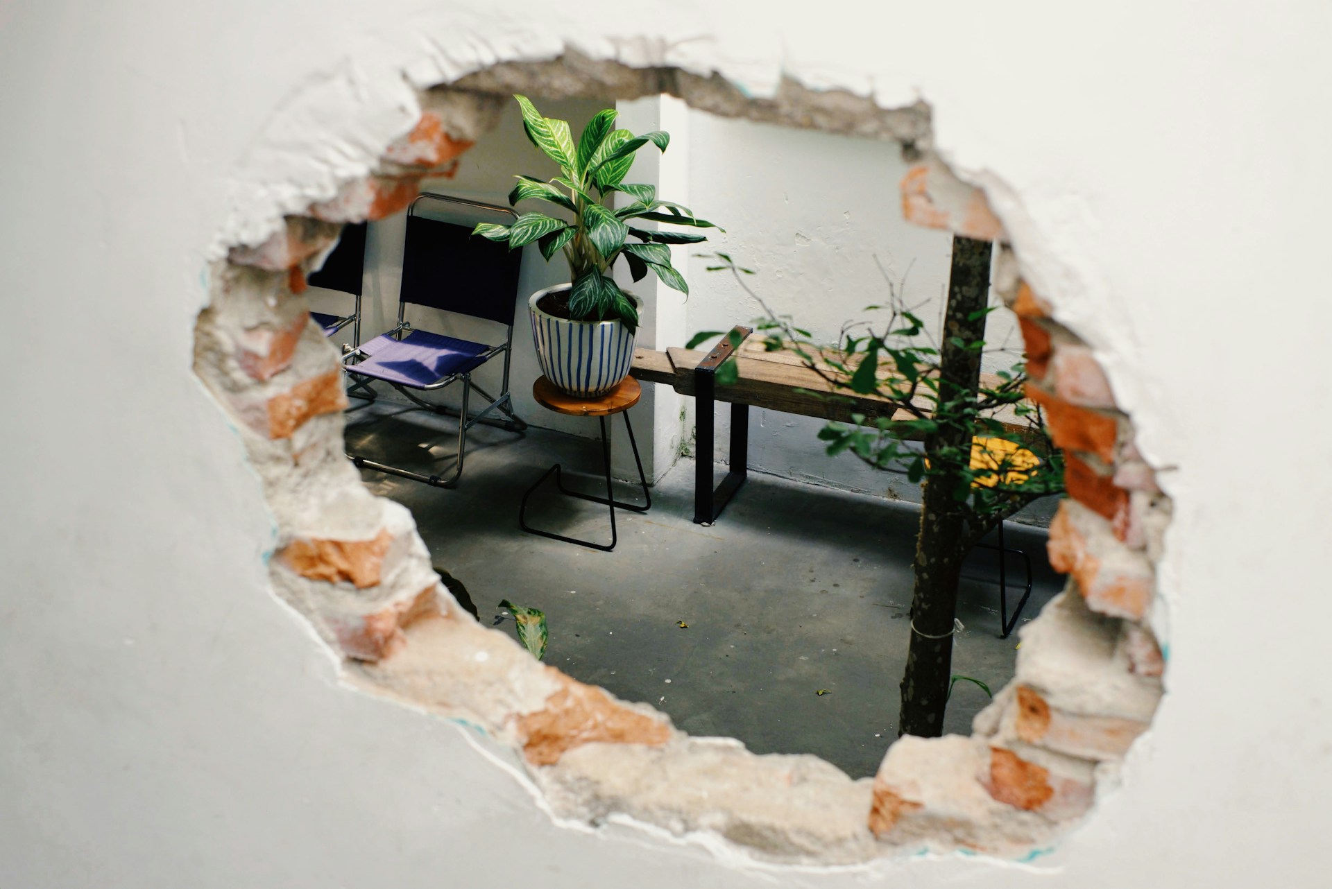 Hole in an apartment wall caused by troublesome guest