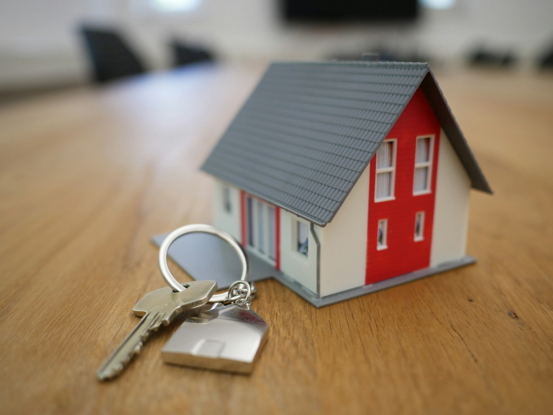 Holiday home model with a key next to it