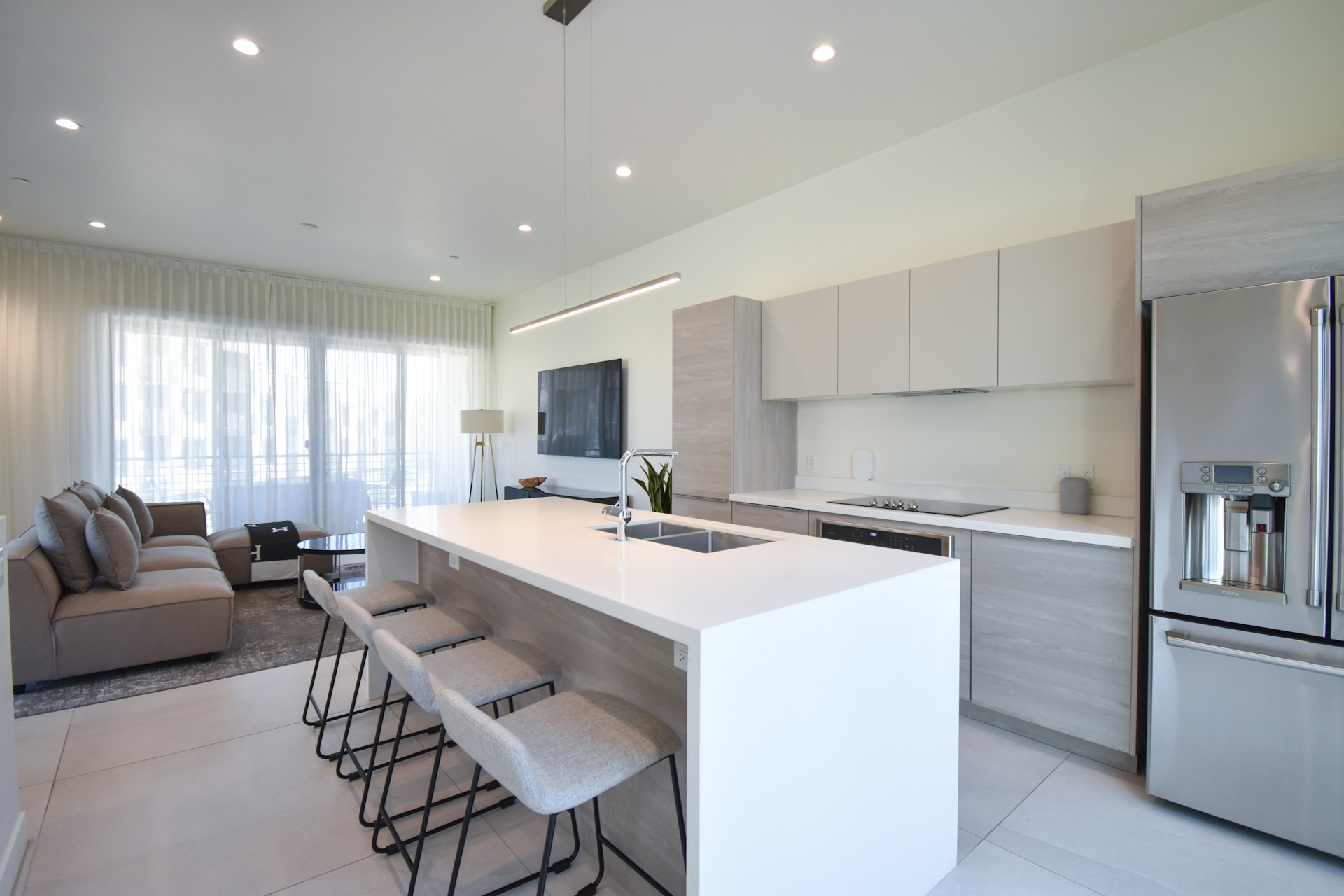 How to start an Airbnb business: A guide for new hosts The living room of a modern airbnb, with open-plan kitchen