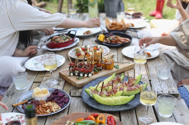 Lee Myungseong Unsplash garden table with bbq food and people sitting around