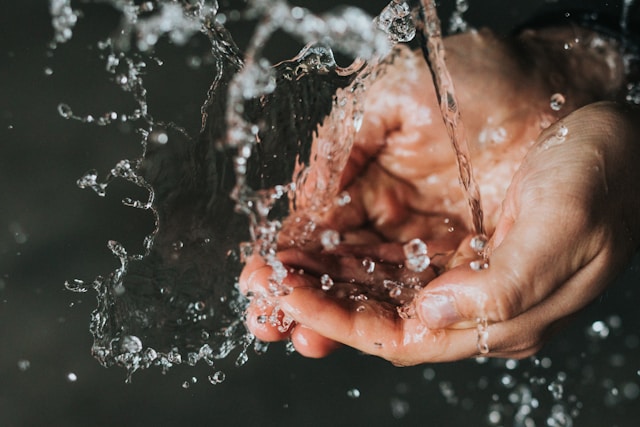 Nathan Dumlao via Unsplash Human catching water with hands