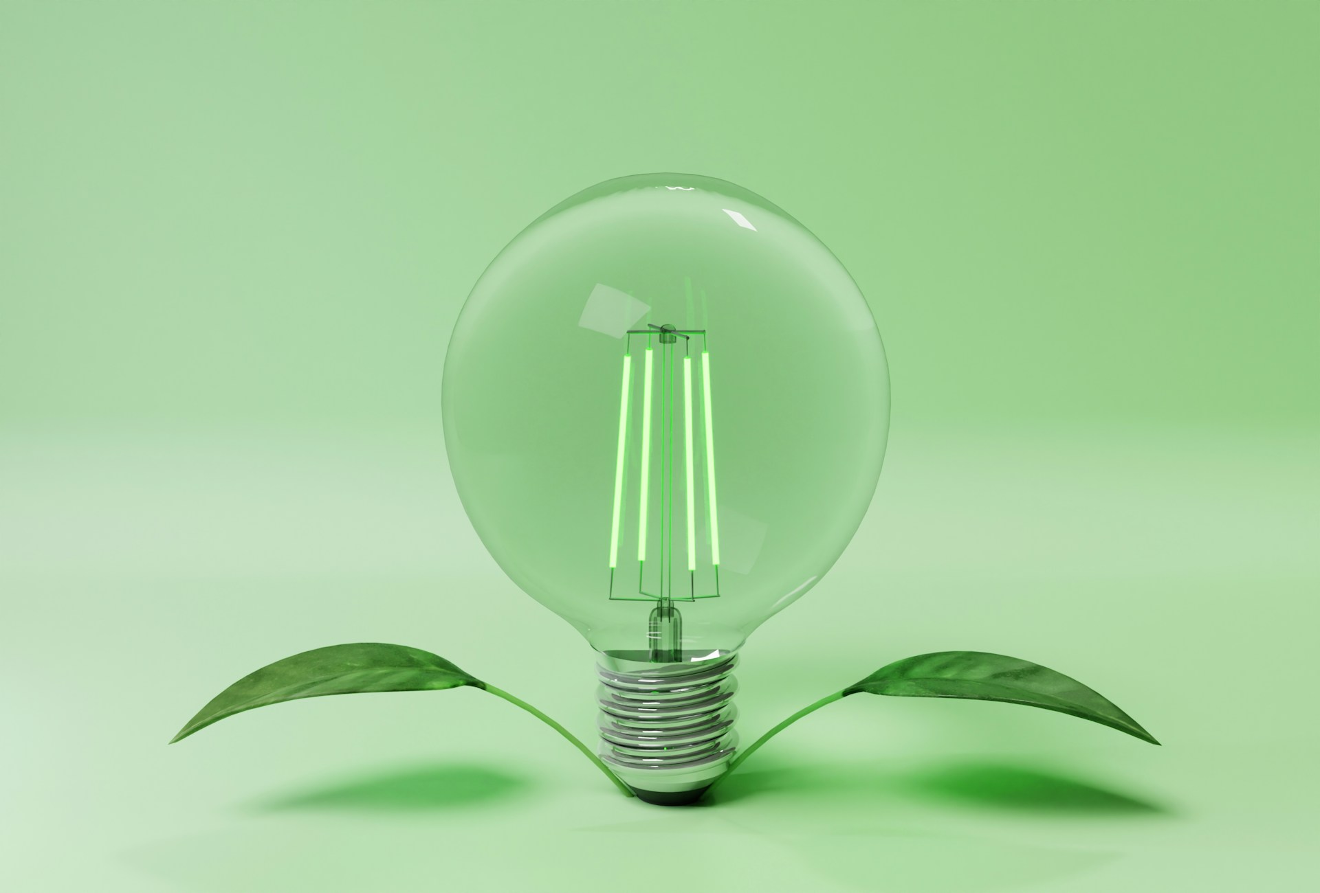 Green LED light bulb with leaves at its base against a green background, symbolising energy-efficient lighting solutions for holiday rentals.