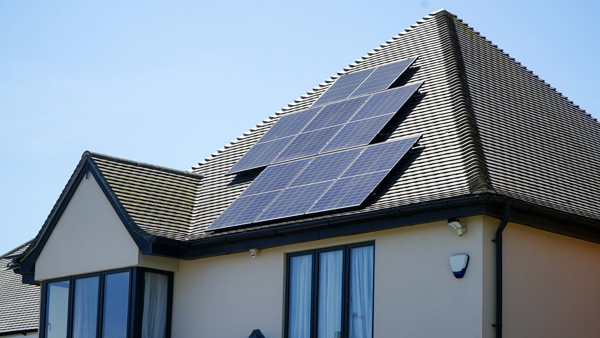 Solar panels on a holiday rental roof representing eco-friendly property upgrades to increase daily rate