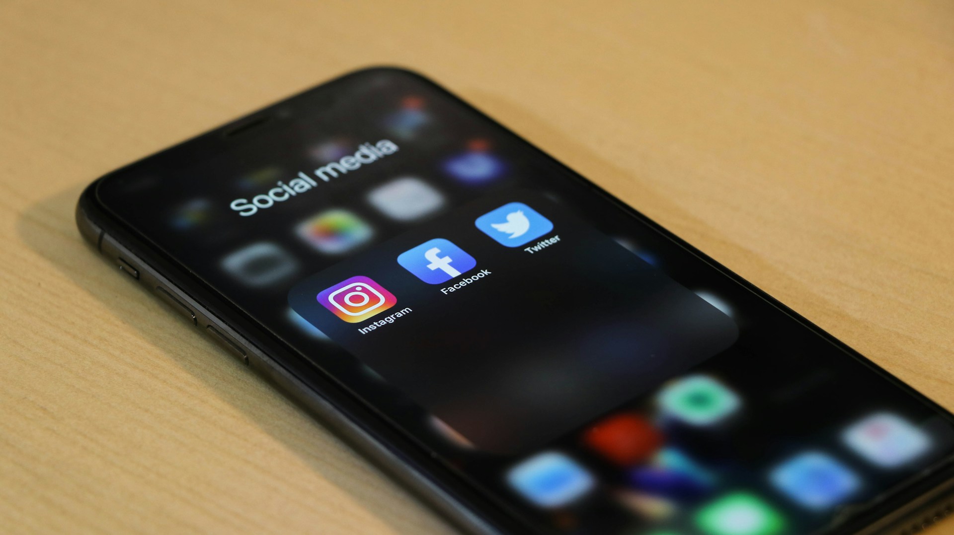 Smartphone screen showing social media apps including Instagram and Facebook representing Black Friday holiday rental marketing